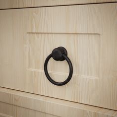 a wooden cabinet with a black handle on it