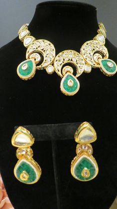 This beautiful choker is a modern twist to traditional jewelry and comes in a gold finish with green stones to match any outfit as desired. The choker is made of high quality stones and is a statement piece that can be dressed accordingly. The set comes with matching earrings for a complete look. Green Hand Set Gold-plated Earrings, Green Hand-set Gold-plated Earrings, Hand Set Green Gold-plated Earrings, Hand Set Green Gold Plated Earrings, Elegant Gold Plated Green Jewelry Sets, Green Gold-plated Kundan Necklace For Festivals, Green Gold Plated Kundan Necklace For Festivals, Elegant Green Gold Plated Jewelry Sets, Elegant Green Gold-plated Jewelry Sets