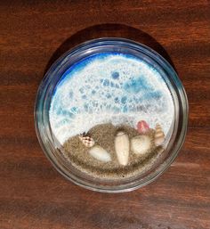 there is sand and sea shells in the jar