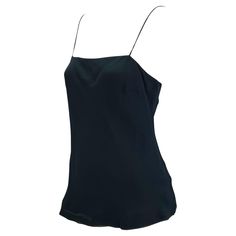 Presenting a sensual Gucci tank top, designed by Tom Ford. This uniquely shaped tank top features spaghetti straps with an a-line construction. Not your average tank top, this shirt was designed for the Spring/Summer 1997 collection and is the perfect chic elevation to the standard tank. Approximate measurements: IT42 35" bust 38" waist 24" shoulder to hem 72% rayon viscose, 28% silk Silk Cami Tank Top With Built-in Bra, Sleeveless Evening Tops With Built-in Bra, Silk Cami Top With Built-in Bra, Summer Silk Tank Top With Built-in Bra, Cami Top With Built-in Bra For Evening, Evening Sleeveless Tops With Delicate Straps, Evening Tops With Spaghetti Straps, Delicate Strap Camisole Tops For Evening, Delicate Straps Camisole Evening Tops