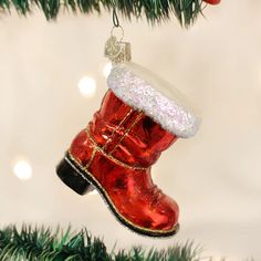 a red boot ornament hanging from a christmas tree