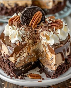 an oreo cookie cake with chocolate frosting and pecans on top