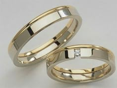 two gold wedding bands with diamonds on them