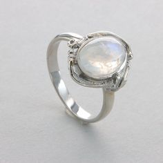 This is a beautiful Rainbow Moonstone Ring in 925 Sterling Silver with a Rhodium finish.  The silver does also not include any nickel or other substances causing most allergies. The ring is thus hypoallergenic. Rhodium makes the silver less tarnish. Size of the Moonstone 1.1 x 0.8 cm 0.43 x 0.31 inch Please note: Our jewelry is photographed close up to show detail and may appear larger than they are. We use a dime coin as size reference on one of the pictures. Usually we ship on the same day we receive the payment for the order. You will receive the item in a gift box - perfect to surprise someone or yourself. We want you to be happy with your purchase. If you do not like what you bough can send it back and we will refund you the money. Please do not hesitate to contact us so we can solve Silver Sterling Moonstone Wedding Ring, Sterling Silver White Gold Moonstone Ring, Sterling Silver Oval Cabochon Moonstone Ring For Anniversary, White Gold Moonstone Ring In Sterling Silver, Silver Moonstone Ring Hallmarked, Silver Polished Moonstone Promise Ring, White Gold Moonstone Ring Stamped 925, Silver Moonstone Crystal Ring In Moon Shape, Polished Silver Gemstones For Wedding