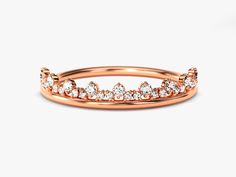 a rose gold ring with diamonds on it