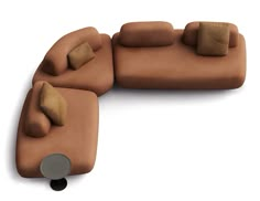 a brown couch with pillows on top of it and a black chair next to it