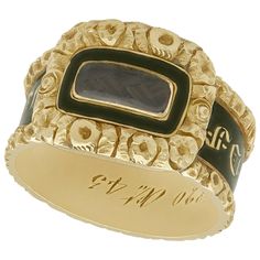 An impressive antique Victorian 1840s black enamel and 14 karat yellow gold mourning ring with hair; part of our diverse antique jewelry and estate jewelry collections. This fine and impressive antique Victorian mourning ring has been crafted in 14k yellow gold. The intricate design is ornamented with a push fit panel to the centre, displaying a woven hair panel. The woven hair panel is bordered by a plain black enamel decoration within a three dimensional floriated frame. The shank of the ring Victorian Hair Jewelry, Antique Ring Box, Victorian Hair, Momento Mori, Ring Boxes, Romantic Jewellery, Victorian Rings, Antique Ring, Vintage Cocktail