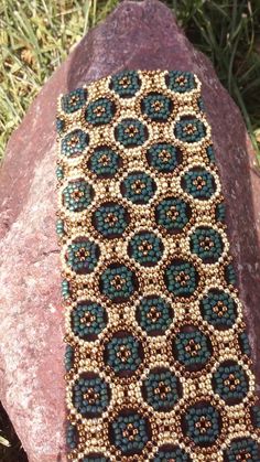 a beaded tie sitting on top of a rock