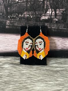 Beautiful artisan earrings handmade by Mexican artisans. Virgin of Guadalupe earrings Artisan Orange Beaded Earrings, Multicolor Our Lady Of Guadalupe Jewelry As A Gift, Multicolor Our Lady Of Guadalupe Jewelry Gift, Handmade Artisan Orange Earrings, Traditional Handmade Orange Earrings, Traditional Orange Handmade Earrings, Traditional Orange Earrings For Gift, Unique Handmade Orange Earrings, Handmade Unique Orange Earrings