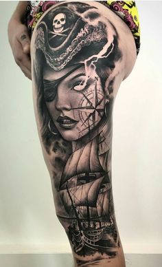 a woman with a pirate ship tattoo on her leg and the lower half of her body