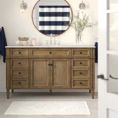 a bathroom with a sink, mirror and rug