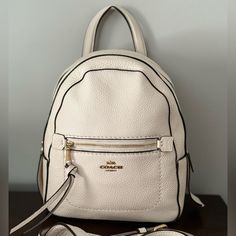 Coach Backpack, Never Used, New With Tags! Cream Color, Comes With Removable Strap Leather Backpack With Zipper Closure In Cream, Cream Leather Backpack With Zipper Closure, Cream Leather Standard Backpack, Chic Cream Satchel Backpack, Coach Backpack With Removable Pouch, Cream Leather Backpack With Adjustable Strap, Cream Leather Backpack For Everyday Use, Luxury Leather Backpack In Cream, Cream Leather Backpack For Daily Use