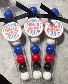 three plastic candy sticks with red, white and blue candies in them