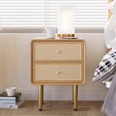 a bedside table with two drawers and a lamp on top