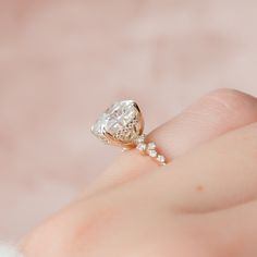 a woman's hand with a diamond ring on it