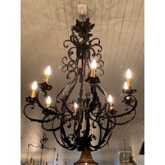 a chandelier hanging from the ceiling in a room with white walls and ceilings