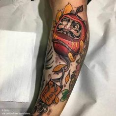 a man's leg with tattoos on it and an image of a cartoon character