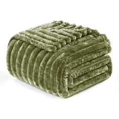 a pile of green towels on top of each other in front of a white background