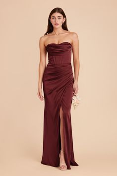 a woman in a long burgundy dress