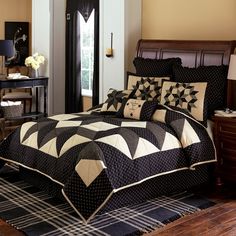 a black and white quilted bed in a bedroom