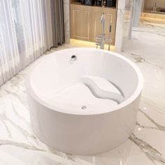 a large white bath tub sitting on top of a marble floor