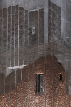 an image of a building that is made out of metal mesh and has rain falling down on it