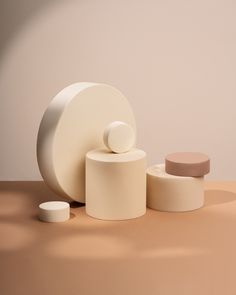 an assortment of white objects sitting on top of a brown table next to each other