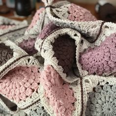 a crocheted blanket is laying on a table