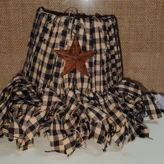 a black and white checkered skirt with a brown star on the top, sitting on a table