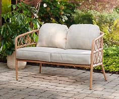 a couch sitting on top of a brick patio