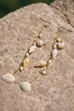 Multi charm earring with shells. 4" Long Affordable Beaded Shell Jewelry, Shell Charms Jewelry, Handmade Dangle Pearl Earrings, Dangle Earrings For Beach, Beach Dangle Jewelry, Shell Dangle Jewelry Gift, Shell Dangle Jewelry For Gifts, White Shell Dangle Jewelry, Handmade Shell Dangle Jewelry