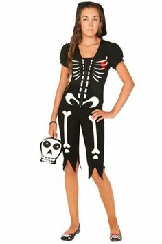 a girl in a skeleton costume is posing for the camera with her hand on her hip