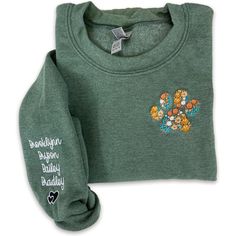 a green shirt with embroidered flowers on it