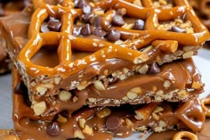 chocolate pretzels and nuts are stacked on top of each other