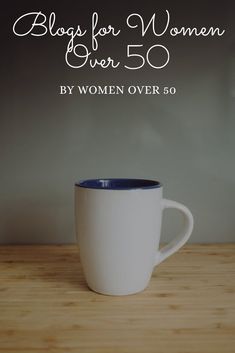 a white coffee cup sitting on top of a wooden table