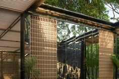 the inside of a house with glass walls and plants in pots on the outside wall