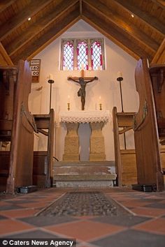 the inside of a church with a crucifix