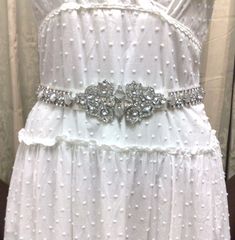 "A unique geometric bridal sash, inspired by Art Deco 1920s Gatsby wedding style. This wedding belt is made of top grade rhinestone crystals and simulated cat's eye gemstones, set onto a tie-back double-sided satin ribbon base, plus more crystals at both ends for added blings. Sash total length (crystal plus ribbon) is 78\" or 200cm. Crystal is about 19 1/2\" (49.5cm) long, 2 1/8\" (5.4cm) wide. Ribbon is 1\" (2.5cm) wide. View all sash belts at https://etsy.me/1aLToLU" Silver Vintage Wedding Dress, Vintage Silver Wedding Dress, White Gatsby Style Wedding Dress, White Wedding Dress With Sashes, White Gatsby Wedding Dress, Elegant White Sashes For Mother Of The Bride, Elegant White Sash For Mother Of The Bride, Fitted Sashes Bridal Belt For Wedding, Fitted Bridal Belt With Sashes For Wedding