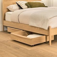 a bed with two drawers underneath it