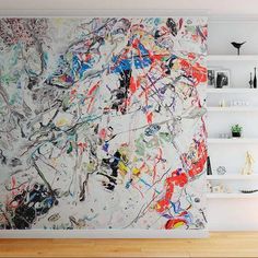 an abstract painting on the wall in a living room