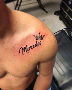 a man with a crown tattoo on his chest that says mercedes in cursive writing