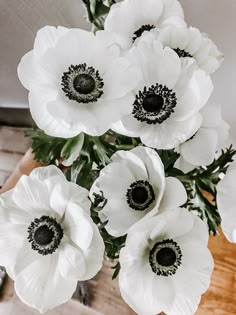 an arrangement of white flowers in a vase