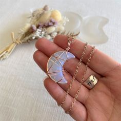 Our beautifully unique Opalite Crescent Moon pendant will make a gorgeous addition to any boho wardrobe.  The polished Opalite is wire-wrapped in tarnish-resistant rose gold wire and comes on a rose gold plated chain.  Pendant is reversible. Pendant dimensions ~ Approx. 40mm x 25mm  Opailite is said to stabilize mood swings, bring inner peace and a sense of calm in any situation. The crescent moon is thought to bring a new lease of energy and positivity, giving us the motivation to achieve our d