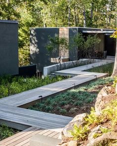 a wooden walkway leading to a building in the woods