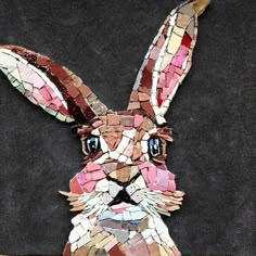 a rabbit made out of mosaic tiles on a black background with the words,'i love