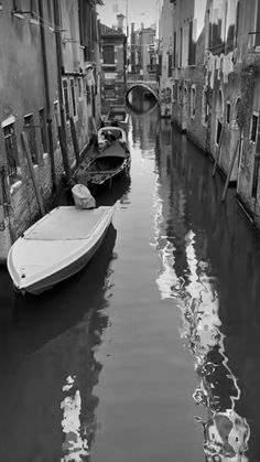 boats are parked along the side of an alleyway in venice, italy photo by matte hester