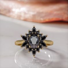 🖤Setting Total Carat Weight: 1.8 Carats 14K Yellow Gold Certificate Of Authenticity Included 🖤Main Diamond: Shape: Oval Weight: 1 Carats Color: Fancy Black Clarity: Opaque Color Origin: Enhanced Color Distribution: Even Grade: AAA Measurements: mm Stock ID: 🖤Accent Diamonds Shape: Round & Marquise & Pear Weight: 0.8 Carats Color: Black Clarity: Opaque Color Origin: Enhanced Color Distribution: Even Grade: AAA Stock ID: Notes: 🖤All diamonds are natural, earth-mined diamonds that were suitable Elegant Black Cluster Ring For Promise, Elegant Black Flower Promise Ring, Black Cluster Ring For Wedding, Fine Jewelry, Black Oval Cluster Ring For Anniversary, Elegant Black Cluster Ring For Formal Occasions, Elegant Black Cluster Ring For Formal Events, Elegant Black Flower Ring, Black Cluster Ring For Anniversary In Fine Jewelry Style, Black Cluster Ring For Anniversary