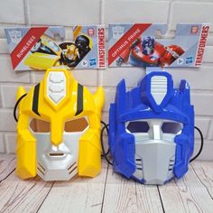 two plastic masks sitting next to each other