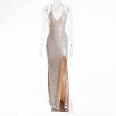 This Ariana Maxi Dress is the perfect choice for a glamorous and chic party look! Featuring a stunning gold sequined design, a flattering v-neckline, and a daring split leg, this dress will turn heads wherever you go. The hollow out back and strappy lace up detailing add a touch of sexiness to this elegant and stretchy dress. Turn your next event into your own personal fashion show with the Ariana Maxi Dress. Material: Polyester V-neck Evening Dress With Side Slits For Party, Gold V-neck Evening Dress For Gala, Glamorous Glitter Maxi Dress, Sequin V-neck Dress For Gala, Glamorous V-neck Evening Dress With Contrast Sequin, Gold V-neck Evening Dress For Prom, V-neck Maxi Dress For Gala Party Season, Glamorous Sequin V-neck Dress For Gala, Glamorous V-neck Sequin Dress For Gala