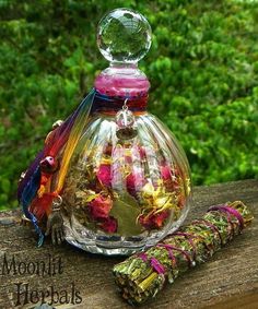 a glass bottle filled with lots of different colored flowers